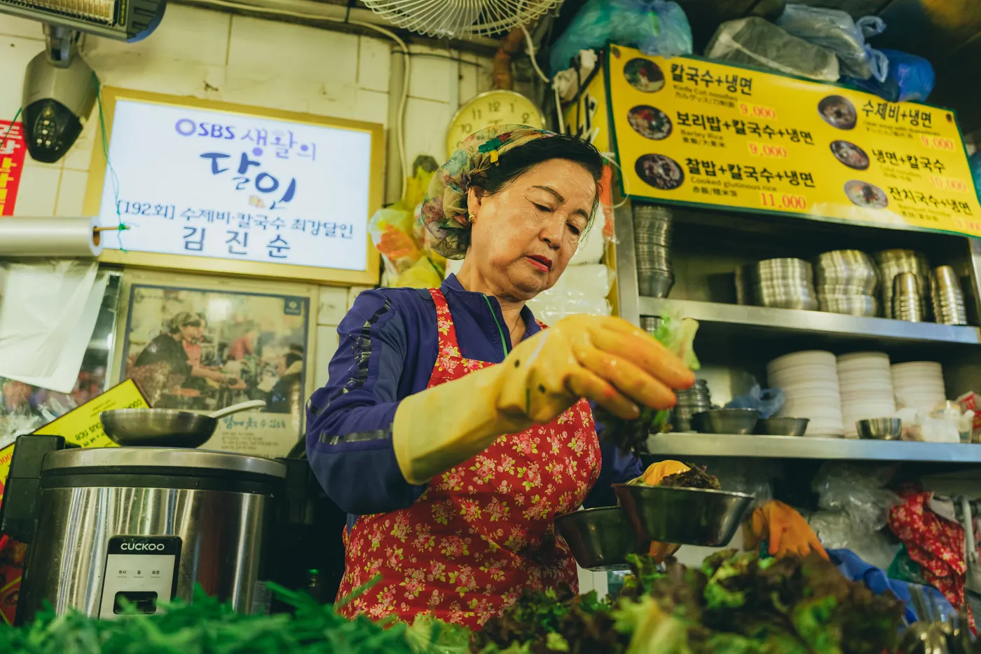 Vendor preparing food in a Korean market